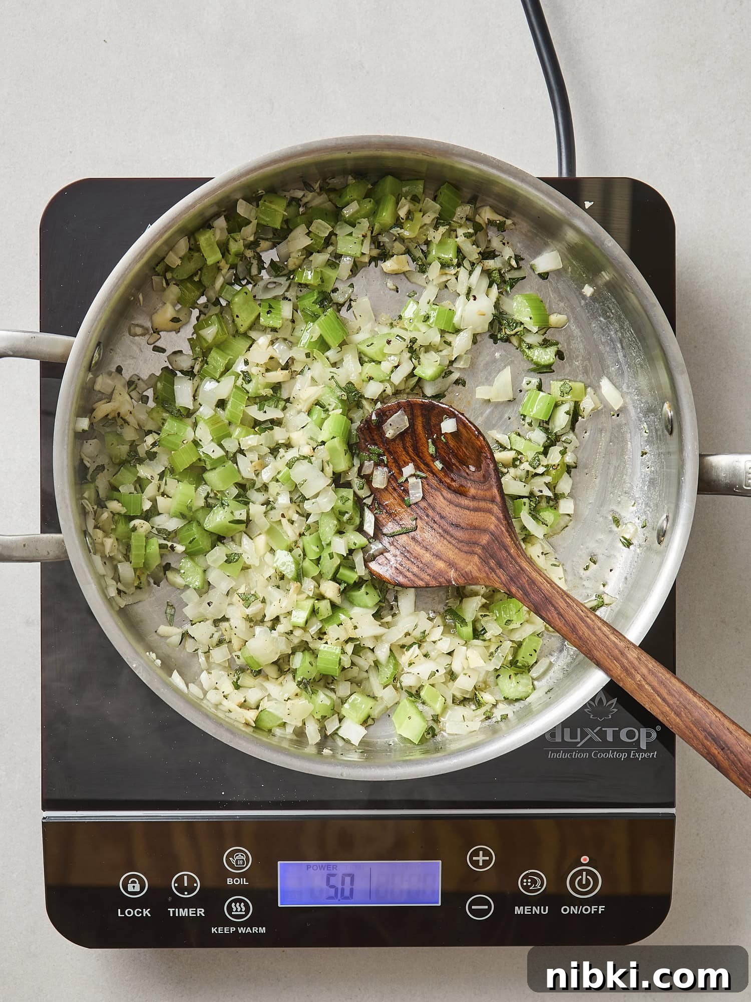 Caramelized Onion and Croissant Stuffing Recipe 9 Aromatics of celery and onion cooking in a pot.