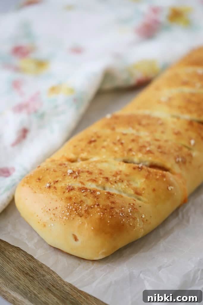 Buffalo chicken stromboli baked and resting on a cutting board.