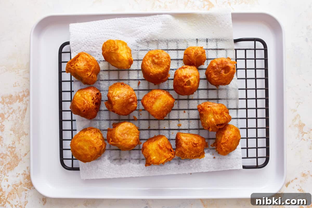 Crispy Fried Banana Fritters Recipe with Cinnamon Sugar 13 Fried bananas on a cooling rack.