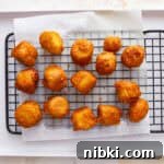Crispy Fried Banana Fritters Recipe with Cinnamon Sugar 8 Fried bananas on a cooling rack.