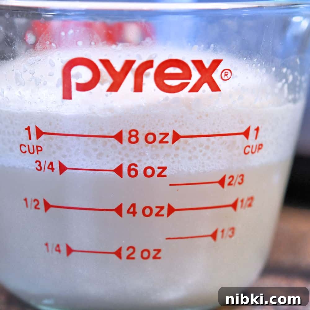 Potato Dinner Rolls: Bread Machine, Hand, or Mixer 6 proofed yeast with a nice foam top in a glass measuring cup