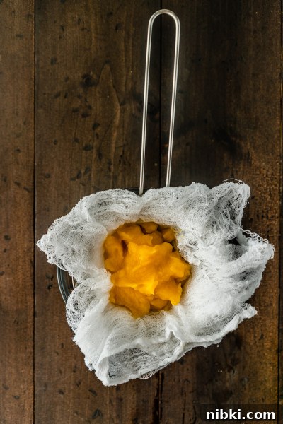Draining pumpkin puree through cheesecloth