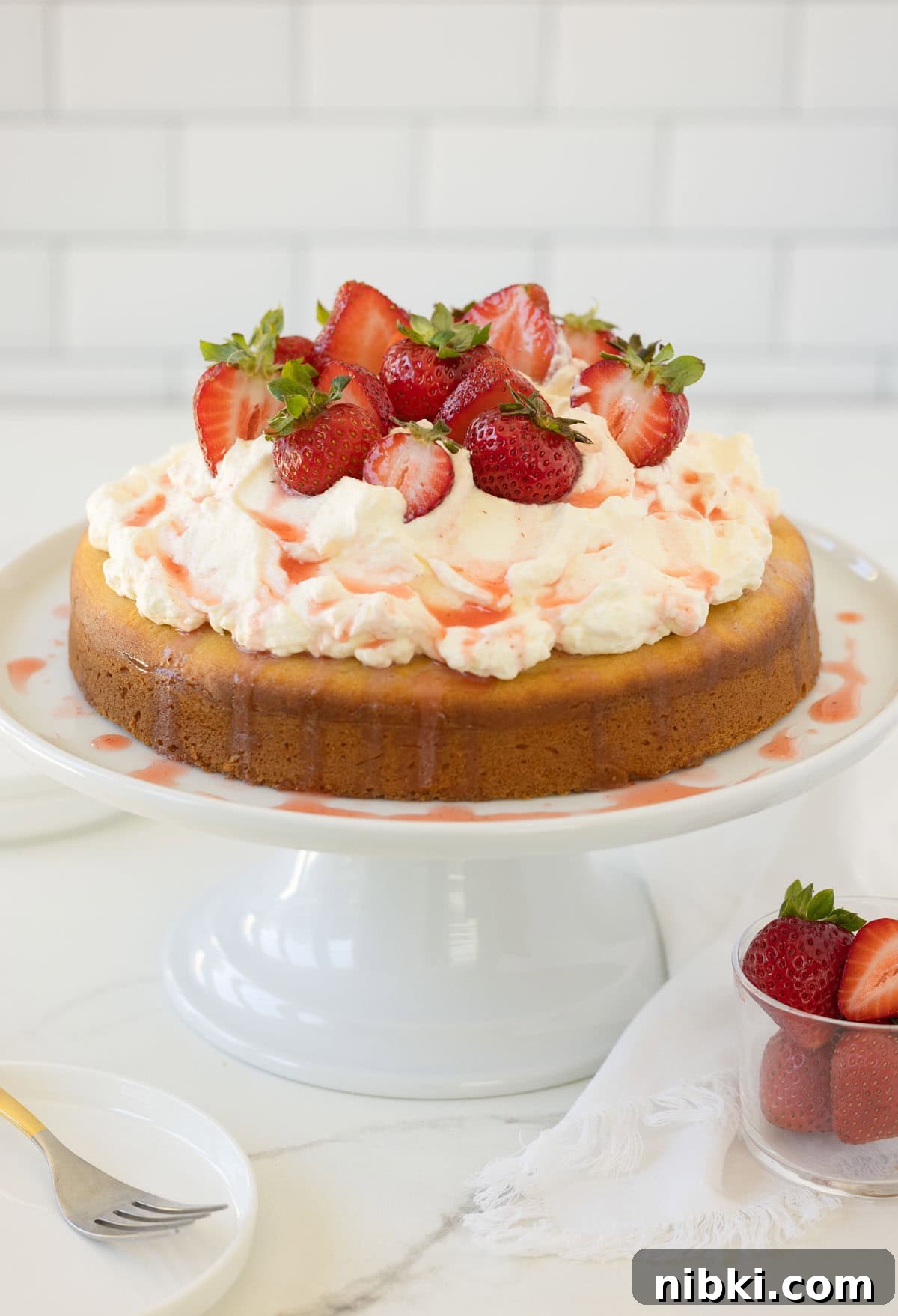 Gluten-Free Strawberry Shortcake Cake Recipe 2 A strawberry shortcake cake piled high with whipped cream and topped with juicy red strawberries.