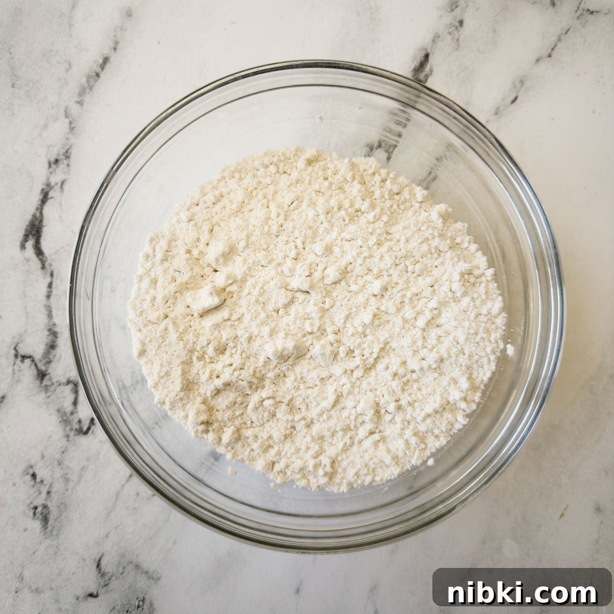 Gluten-Free Strawberry Shortcake Cake Recipe 5 Sifted flour and other dry ingredients in a glass bowl for baking a cake.