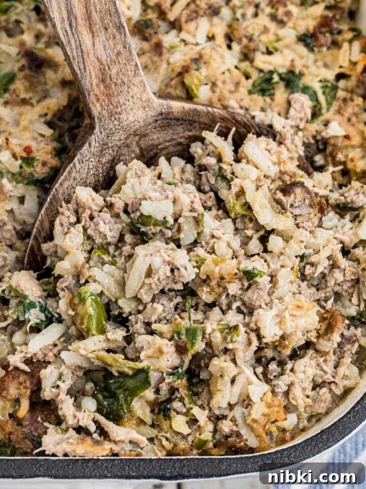 Close up of the corner of a casserole dish of Cajun rice dressing.