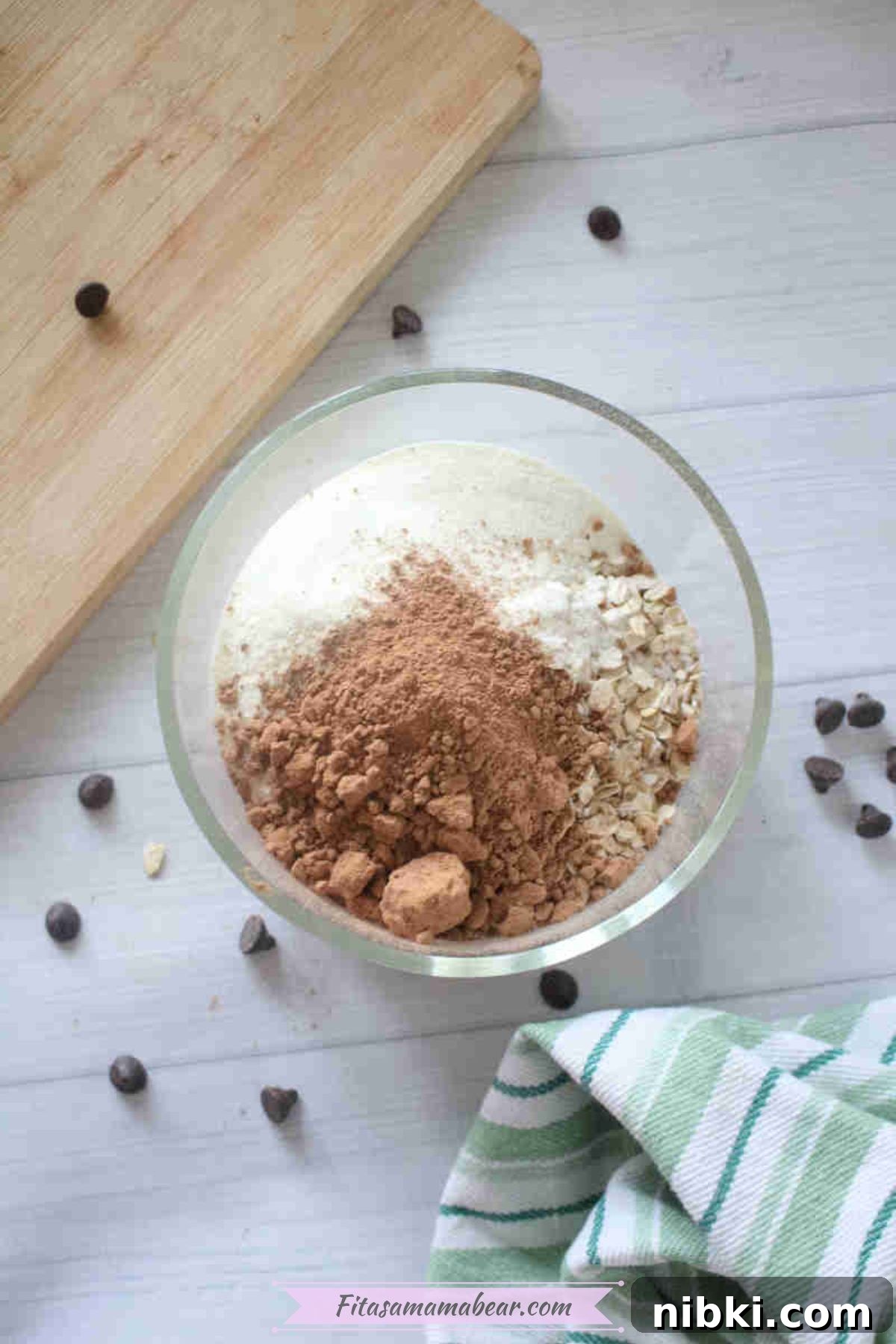 Dairy-Free High-Protein Chocolate Overnight Oats 4 Bowl with cacao powder, oats, and collagen and chocolate chips around it.