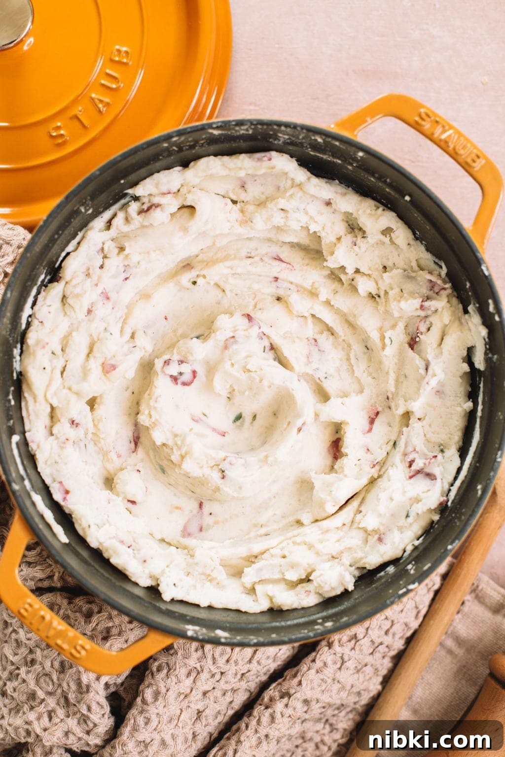 smooth and creamy garlic mashed red potatoes in yellow dutch oven