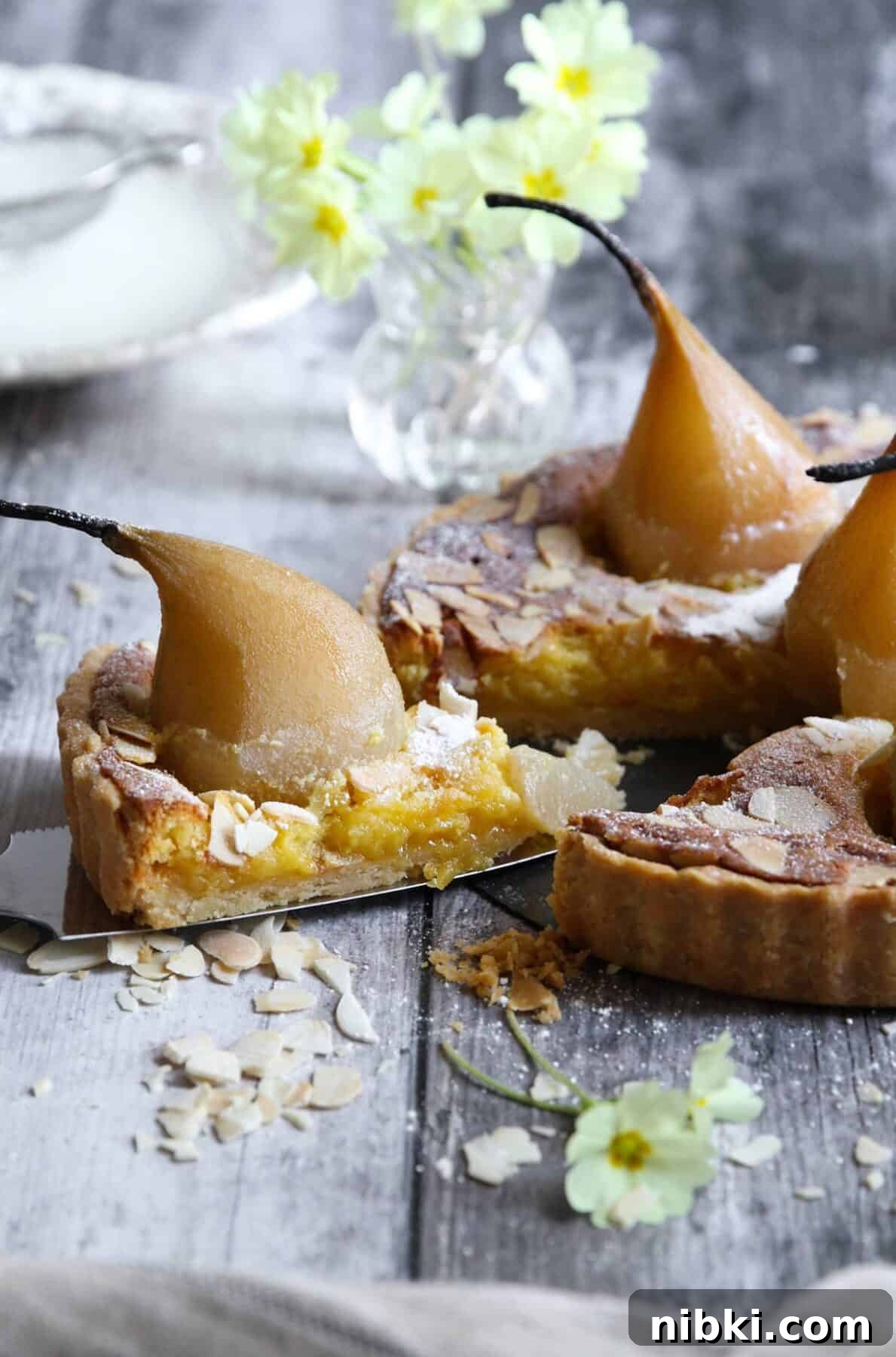 Poached Pear and Almond Tart Recipe 5 A slice with a whole pear cut out of the tarte bourdaloue.
