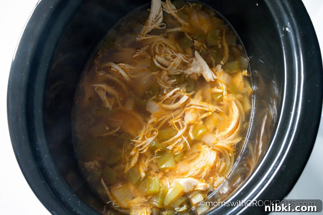 This simple slow cooker soup really packs a punch of flavor! Try this delicious Crockpot Jalapeno Popper Chicken Soup Recipe! Great for game day or any day!