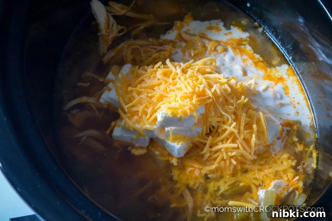 This simple slow cooker soup really packs a punch of flavor! Try this delicious Crockpot Jalapeno Popper Chicken Soup Recipe! Great for game day or any day!