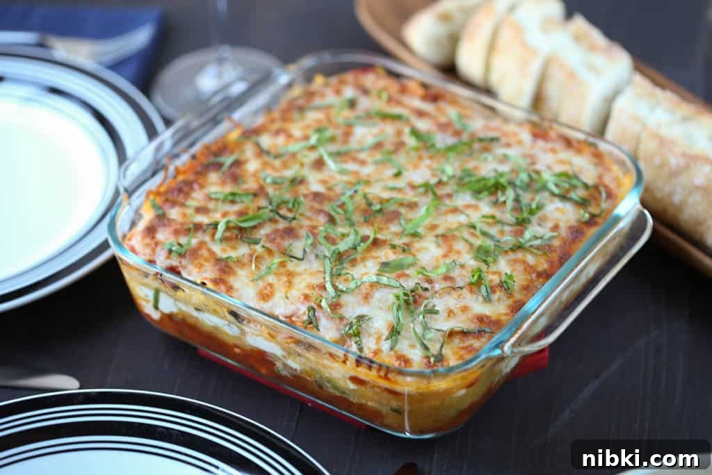 Spaghetti Squash Lasagna Recipe 4 spaghetti squash lasagna on a wooden table with bread and plates.