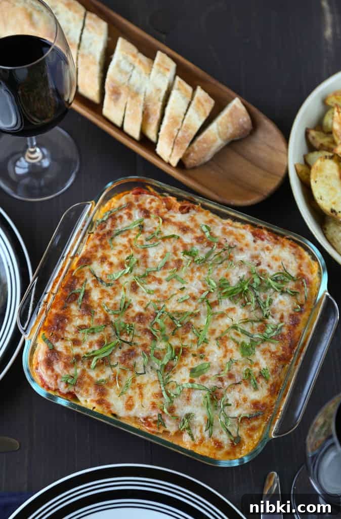 Spaghetti Squash Lasagna Recipe 5 spaghetti squash lasagna on a dinner table with plates and sliced french bread.