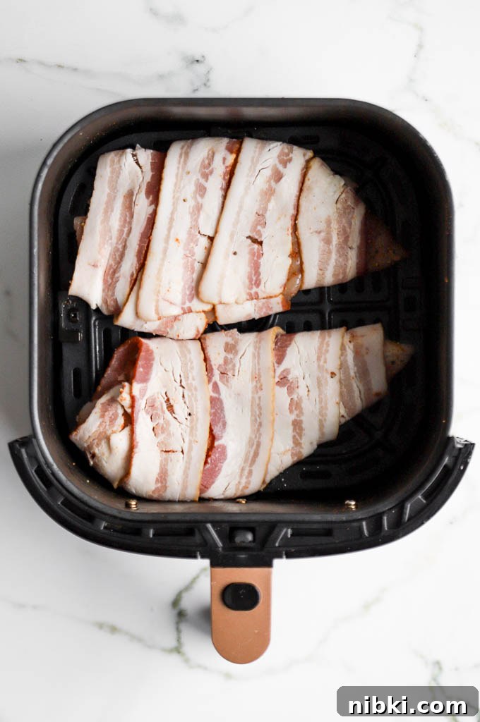 Air Fryer Bacon-Wrapped Chicken Breast: Crispy and Juicy 5 keto bacon wrapped chicken in air fryer basket