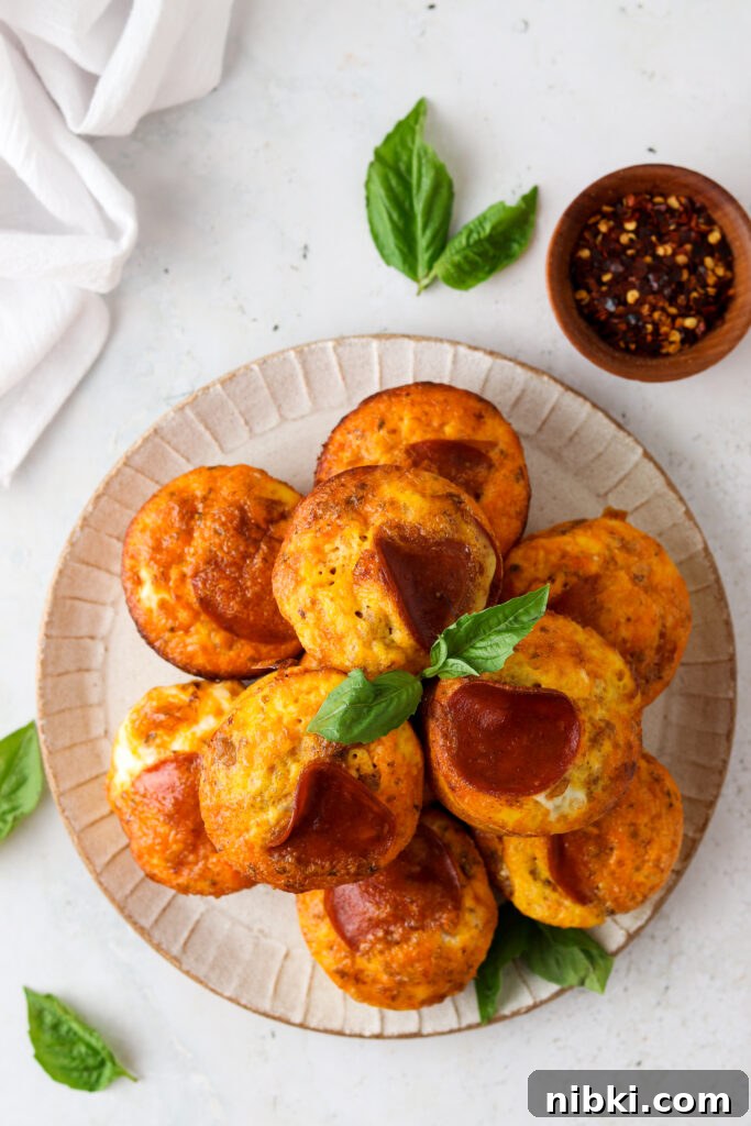 pizza egg muffins on a plate with basil