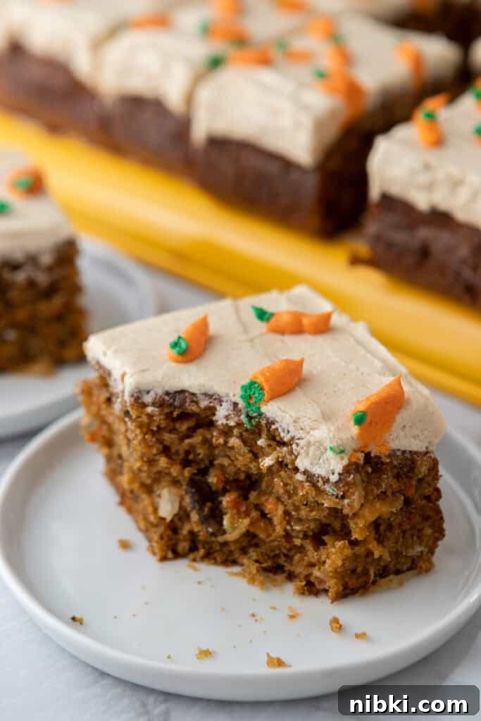 Moist Carrot Sheet Cake Recipe (9x13 Pan) 4 Slice of moist carrot cake sheet cake with cream frosting on white plate