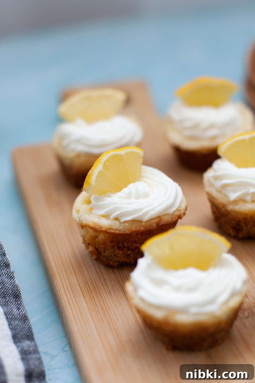 mini lemon cheesecakes on a wood board